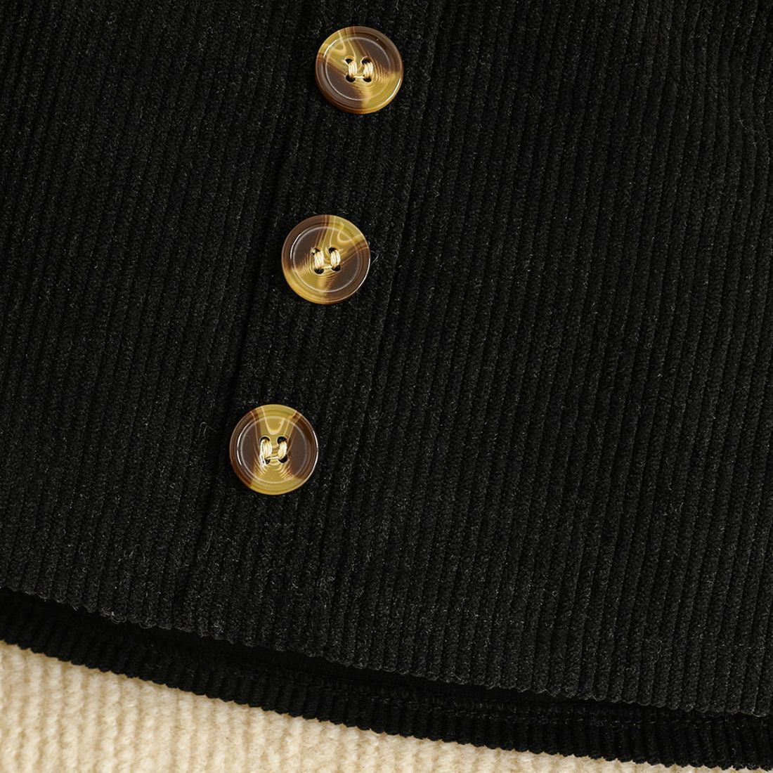 Close up of Black skirt with button decor